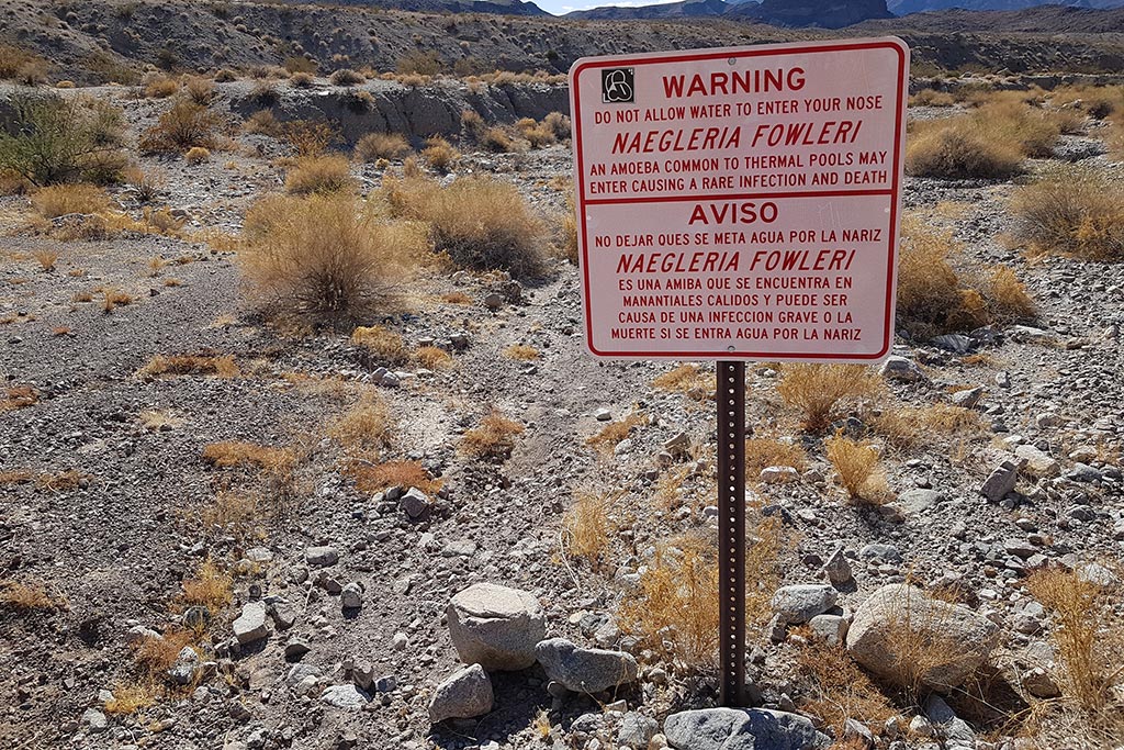 Information sign on the trail warning against potential danger of amoeba naegleria fowleri in arizona hot springs.