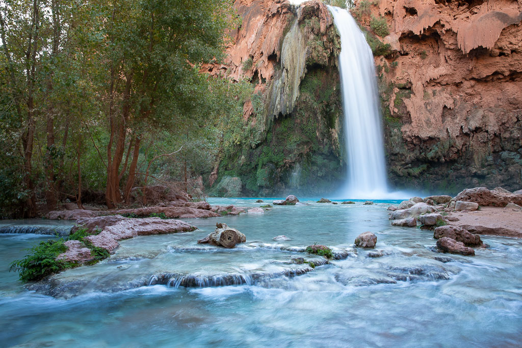 havasu falls in havasupai - the stunning view of blue water and waterfalls on the orange wall.