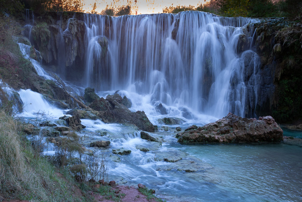 Little Navajo Falls: water cascades down the vertical walls of the canyon. 