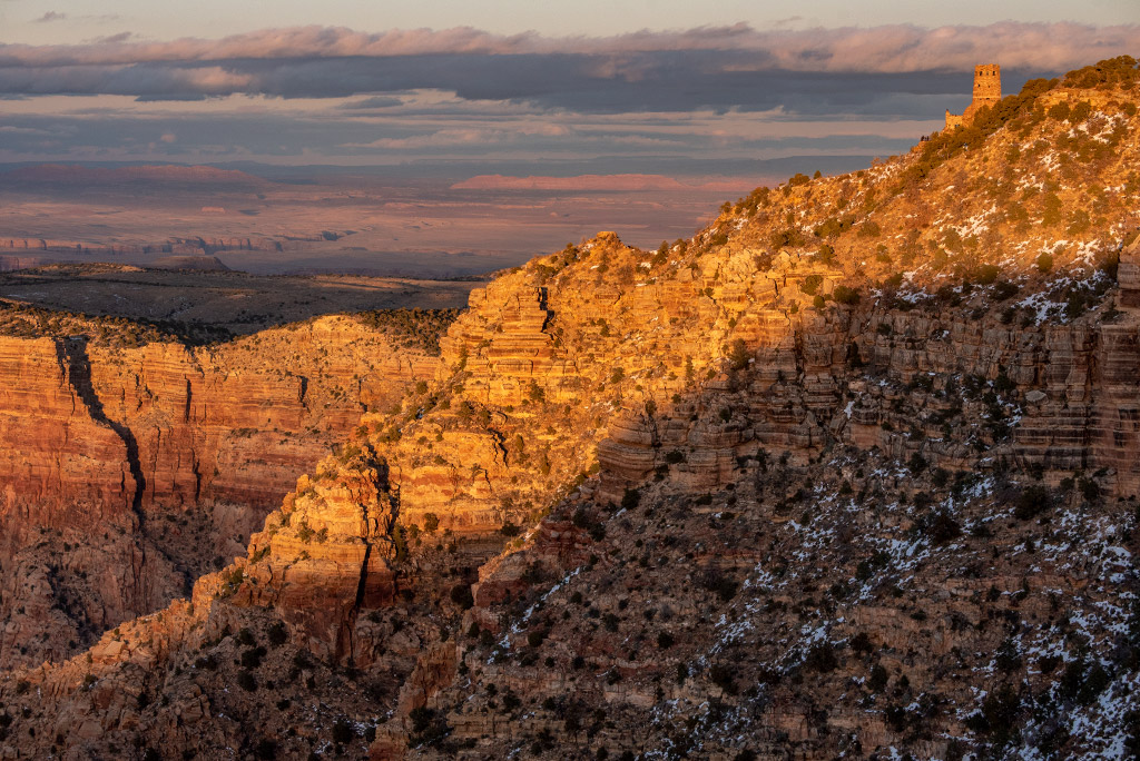 sunset view from Navajo Point in the Grand Canyon with the watchtower in the backdrop.