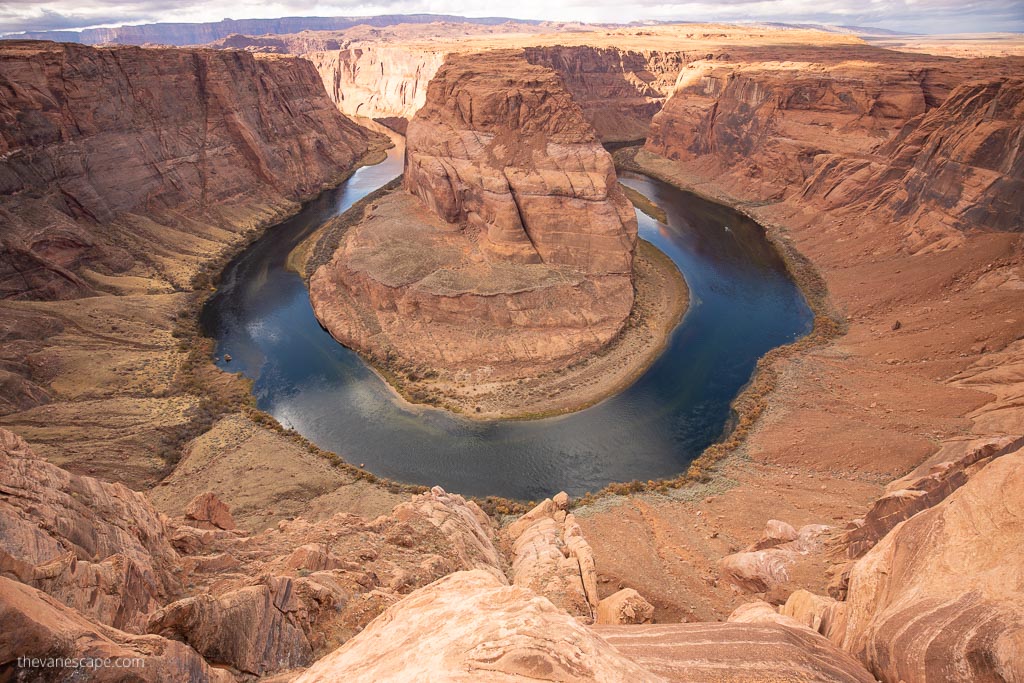 blue water and orange rock clifss at  Horseshoe Bend near Page, Arizona.