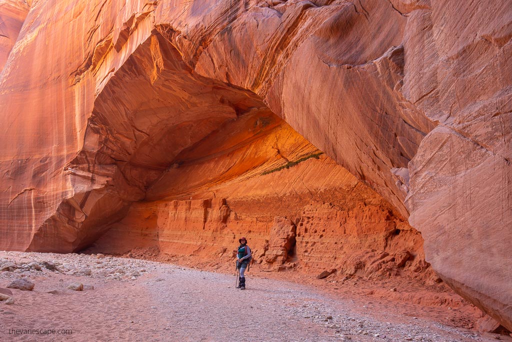 Agnes Stabinska, the author and co-owner of the Van Escape blog on Buckskin Gulch Day Hike among oranges rock walls.