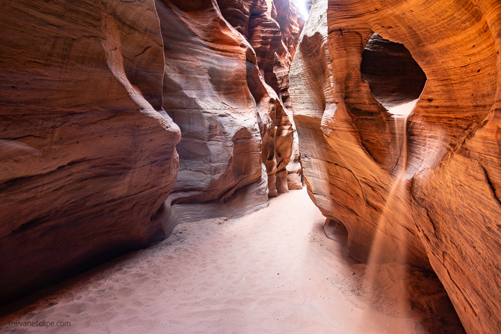 sand and oranges rock formations and narrows walls during buckskin gulch hike.