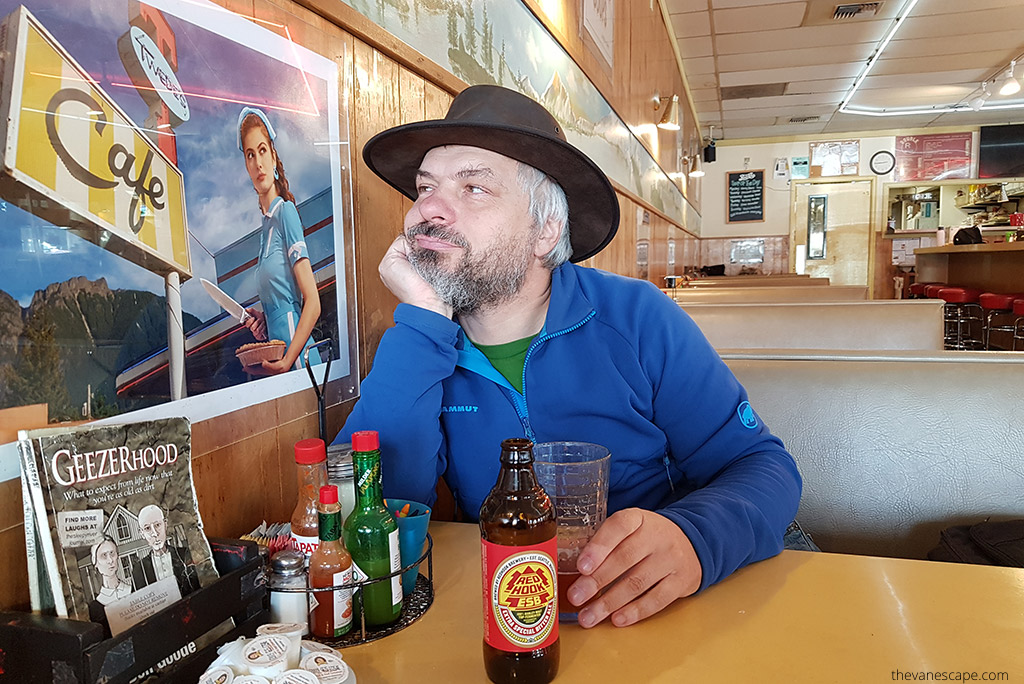 Chris, co-owner of the Van Escape blog is wearing a cowboy hat and he is sitting in Double R Diner. He is looking for a poster with  Shelly Johnson from Twin Peaks on it.