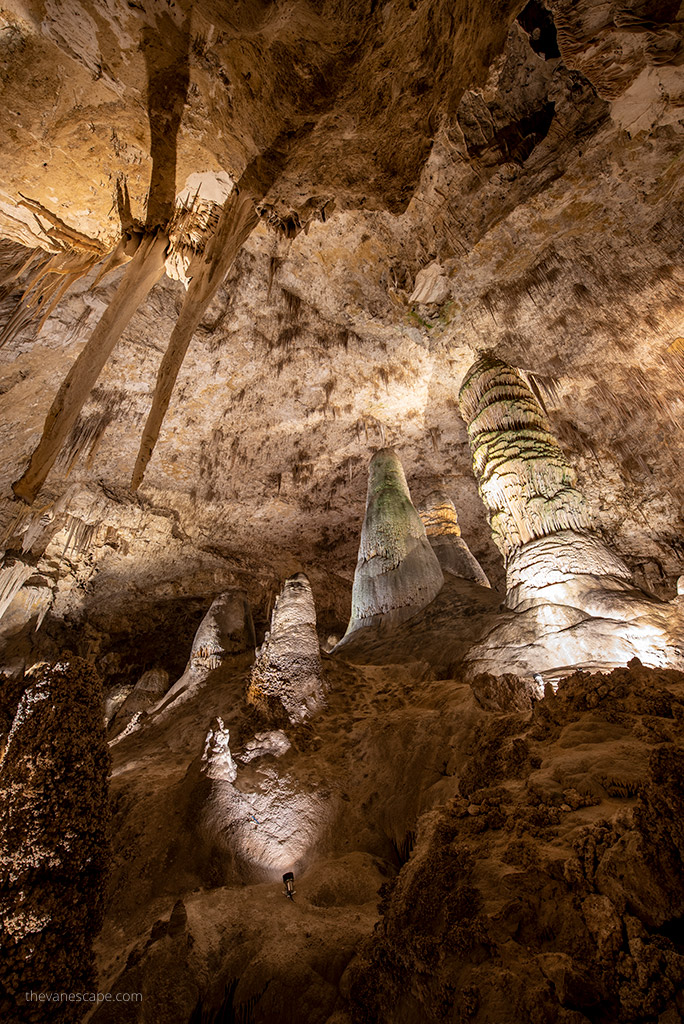 Stalactites and stalagmites in the softly lit cave.