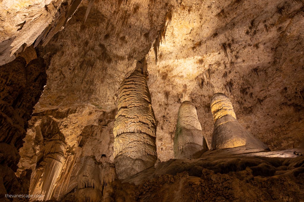 Stunning stalactites and stalagmites in the softly lit cave.