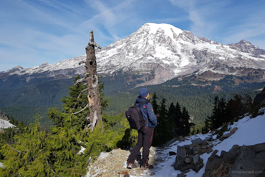 Chris Labanowski, co-founder of the Van Escape blog, on the gikig trail in  Mount Rainier naional Park with stunning mountain vistas.