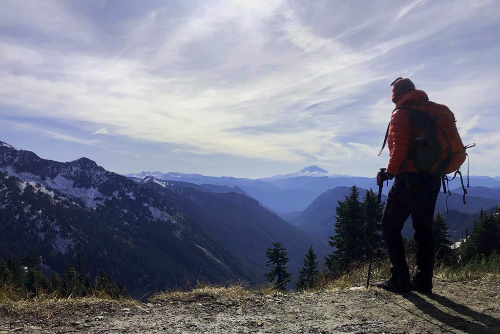 Agnes Stabinska, tha author, during day hike in the mountain with a backpack and trekking poles.