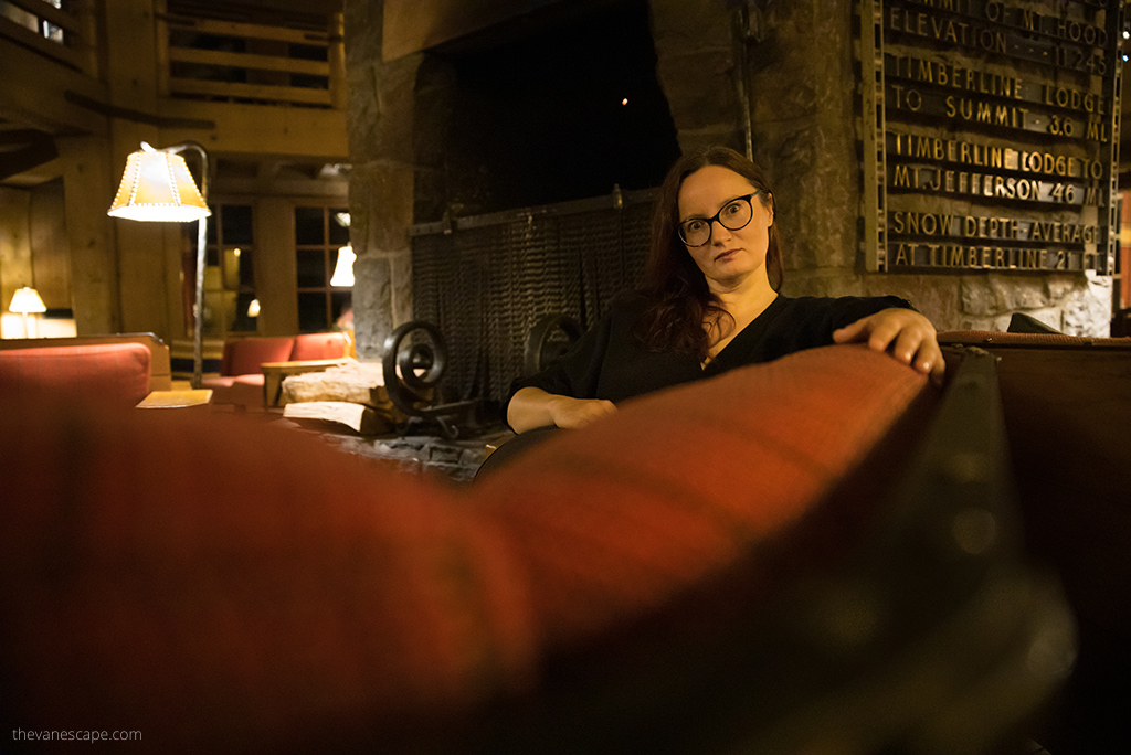 Agnes Stabinska, the author, sitting on the orange sofa in the Shining Hotel in Oregon.