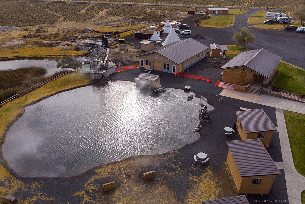 Crystal Crane Hot Springs the view of the large hot pool and wooden houses, teepee and campground.