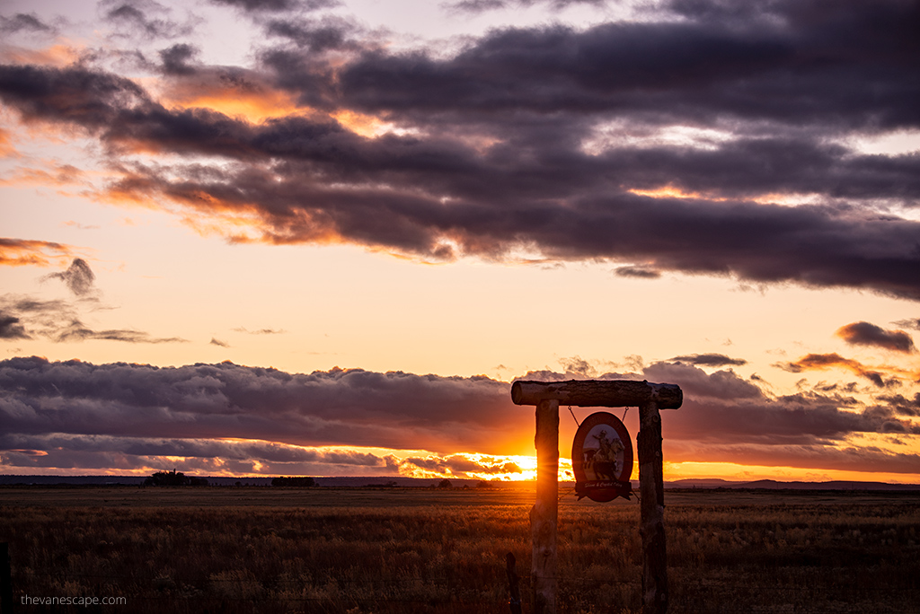 sunset over Sisters Oregon, the sky is orange and pink.