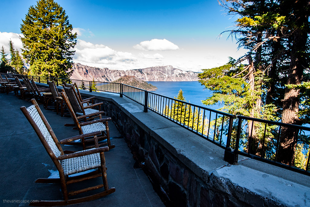 the wooden chairs on the porch of the Crater Lake Lodge with the lake view.