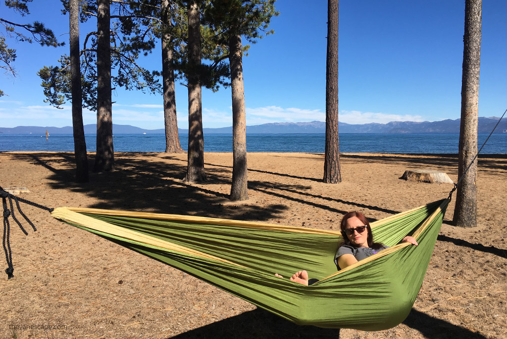 Agnes Stabinska, the author, is in a hammock between a trees with the view of Lake Tahoe.