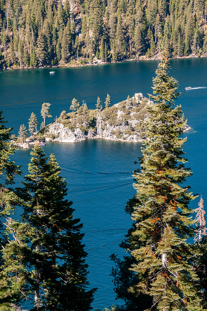 island on the blue water of Lake Tahoe surronded by Tahoe Rim Trail.