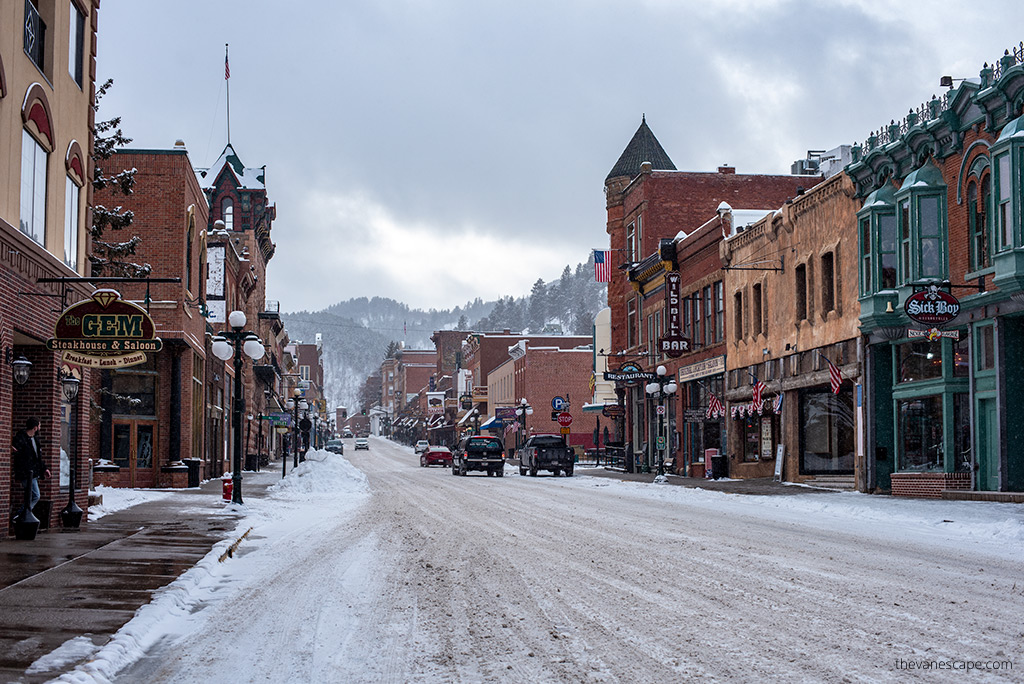 main street in Deadwood with hotels and restaurants in winter scenery.