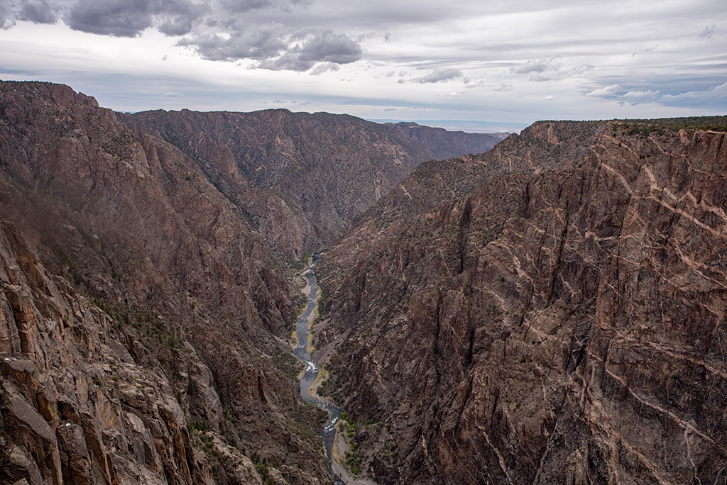 the deep canyon view with river in the bottom during South Rim Road Drive in Black Canyon of the Gunnison National Park. 