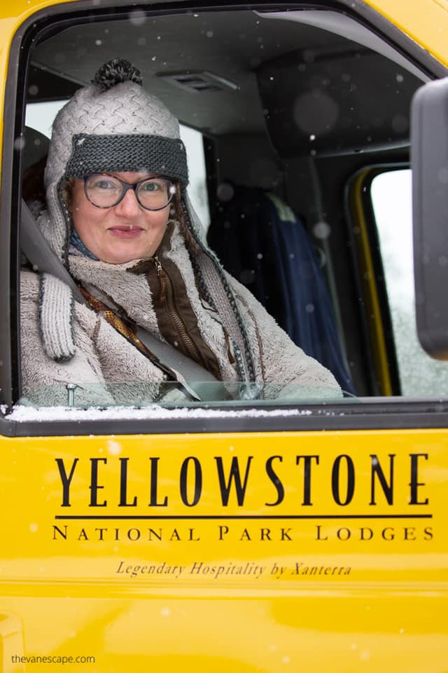 Agnes in a yellow snowcoach during  winter trip to Yellowstone.