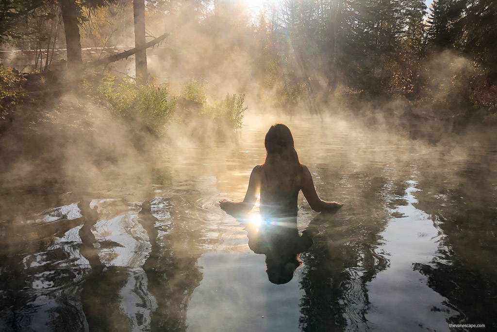 Agnes Stabinska, the author, is soaking in Liard River Hot Springs in the morning sun and fog.