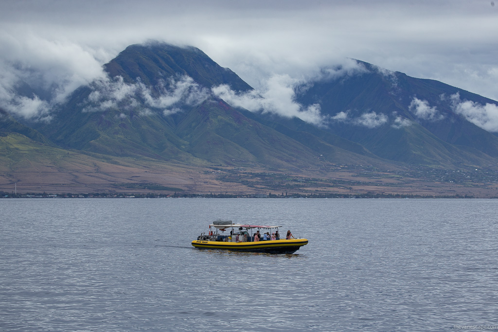 Hawaii boat on the sea with mountains in the backdrop.
