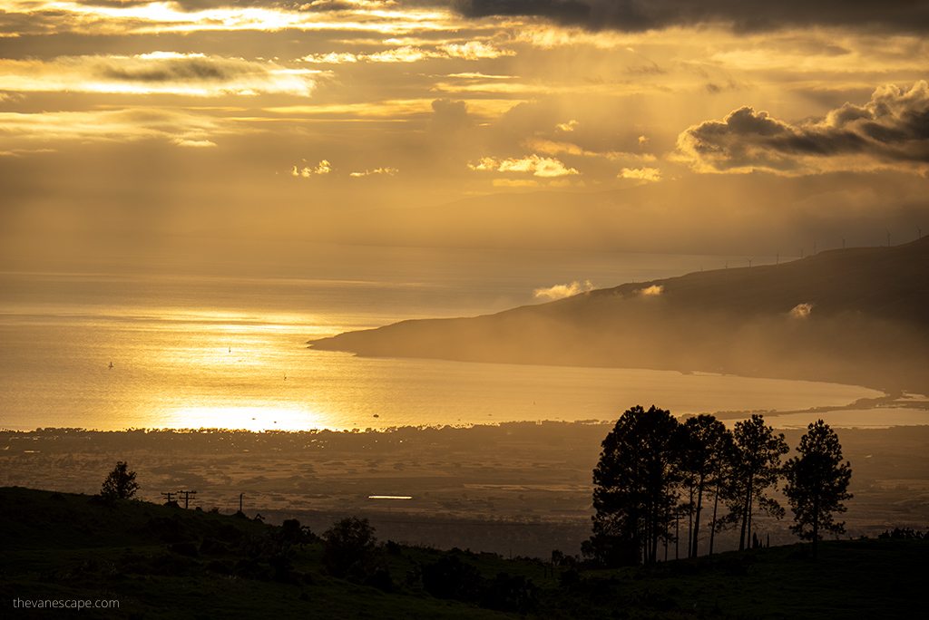 Maui Itinerary- A golden sunset over Maui - overlooking the sea and hills