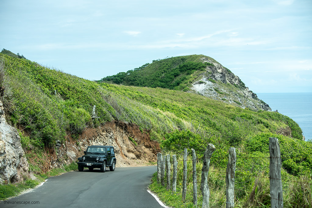 Our rented Jeep Wrangler in which we drove around the island at a bend in the road.