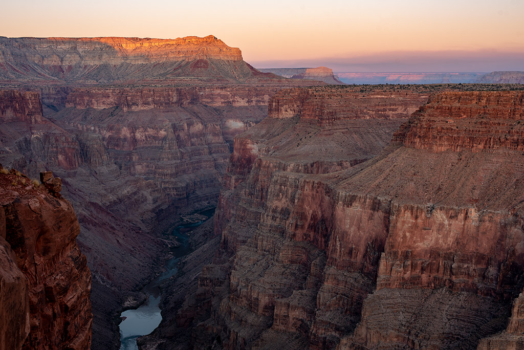 stunning view of the Colorado River from the high cliff at Toroweap Overlook during sunset.