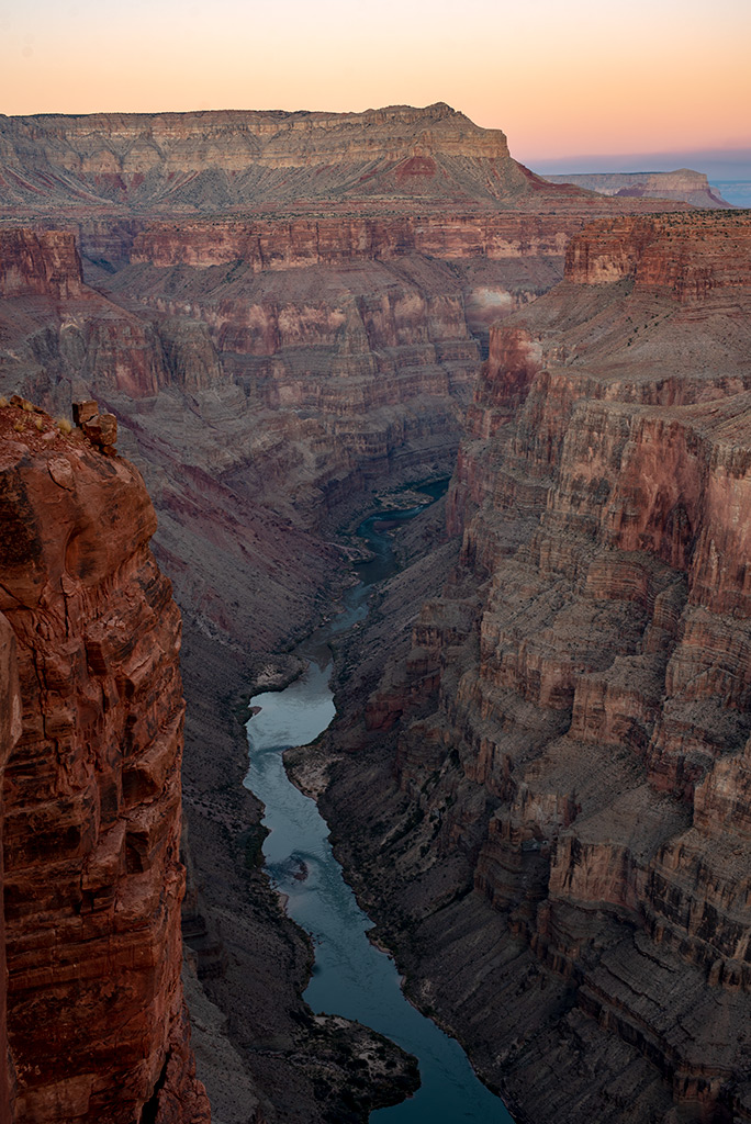 Toroweap Overlook with Colorado River at the bottom of deep canyon during sunset.