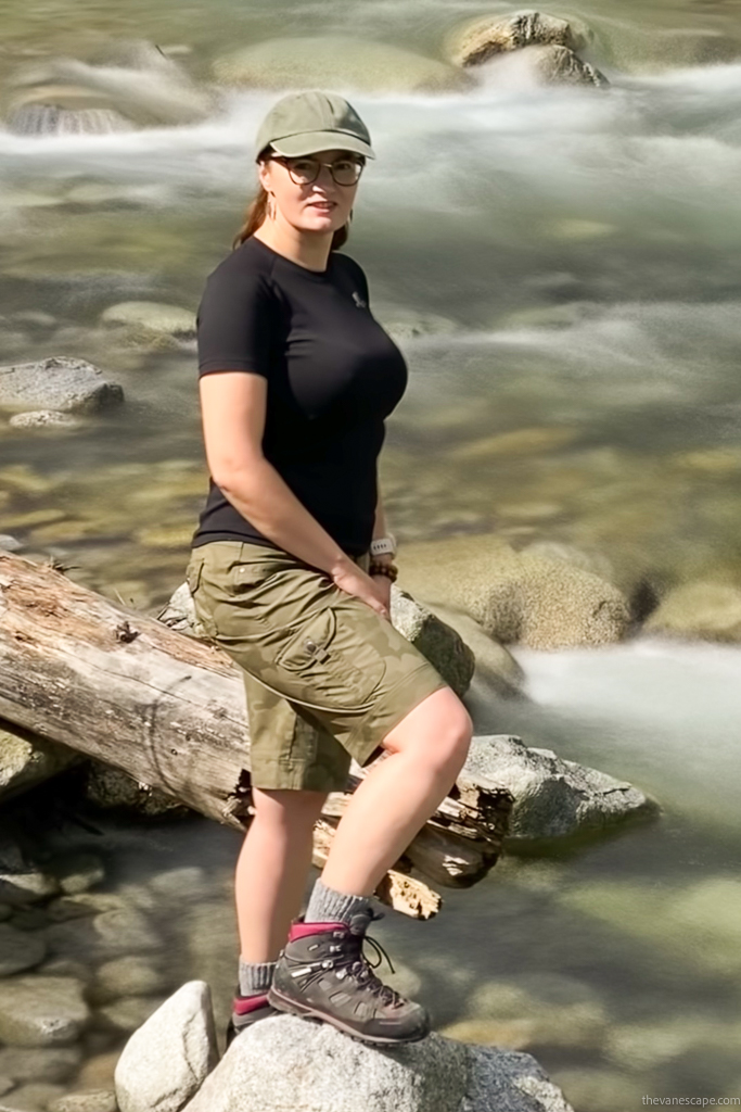 Agnes Stabinska in KUHL SPLASH 11" Hiking Shorts and hiking boots in the river.