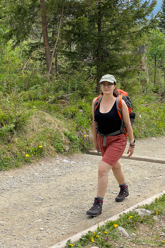 Agnes Stabinska in KUHL KULTIVATR Women's Shorts and hiking boots on the hiking trail in the forest.