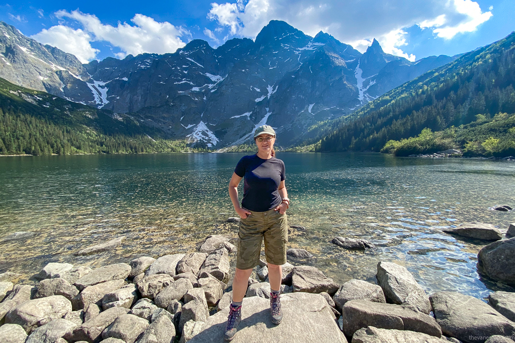 Agnes Stabinska, the author, in the Tatra Mountains with stunnig lake and moutain view. She is wearing KUHL SPLASH 11" hiking shorts and hiking boots.