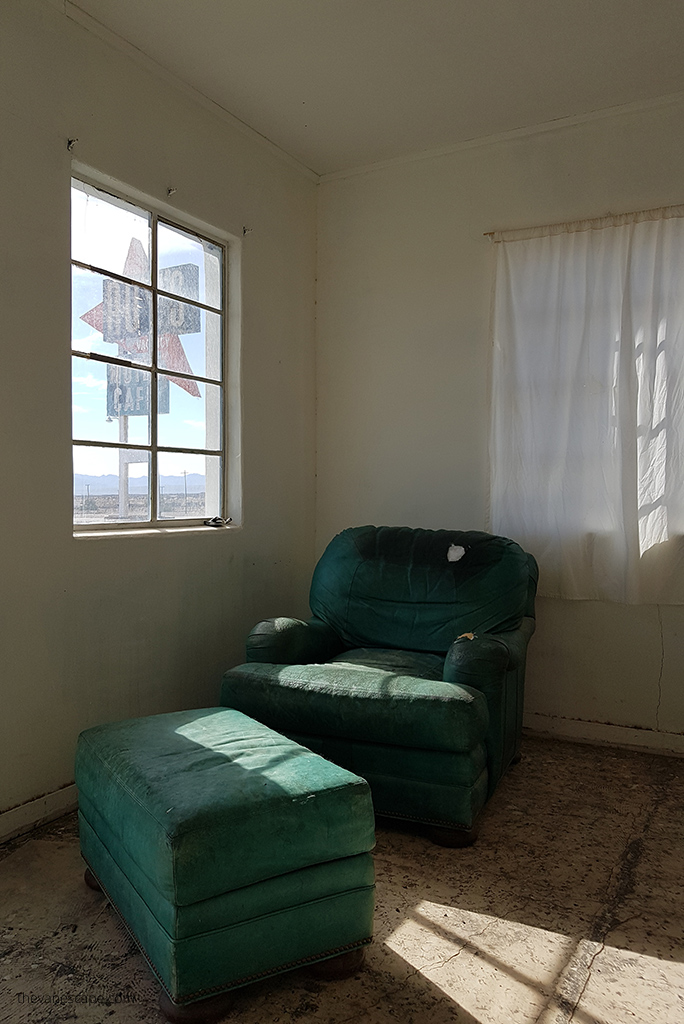 room with old green chairs in Amboy