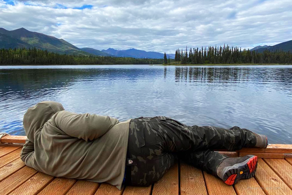 Chris in KUHL SILENCR ROGUE KARGO PANTis  admiring the lake and forest view. 