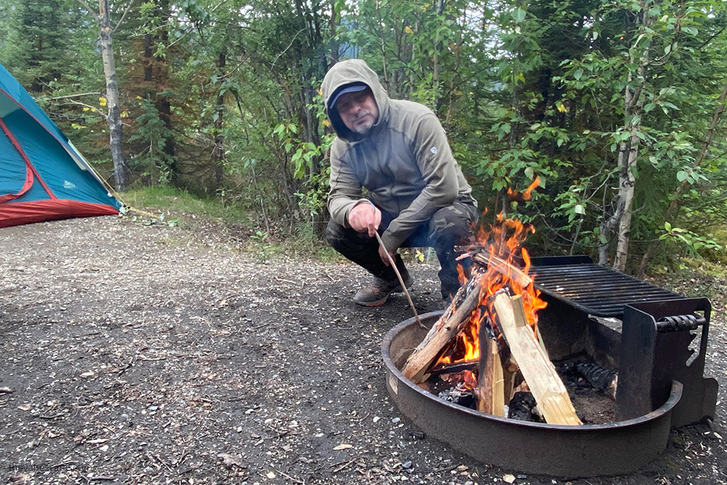 Chris in KUHL SPEKTER Full Zip Hoody next to campfire.