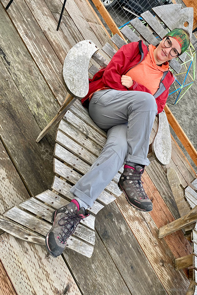 Agnes Stabinska in sitting on bench Homer, Alaska. She is wearing KUHL FREEFLEX ROLL-UP Pants and hiking boots.