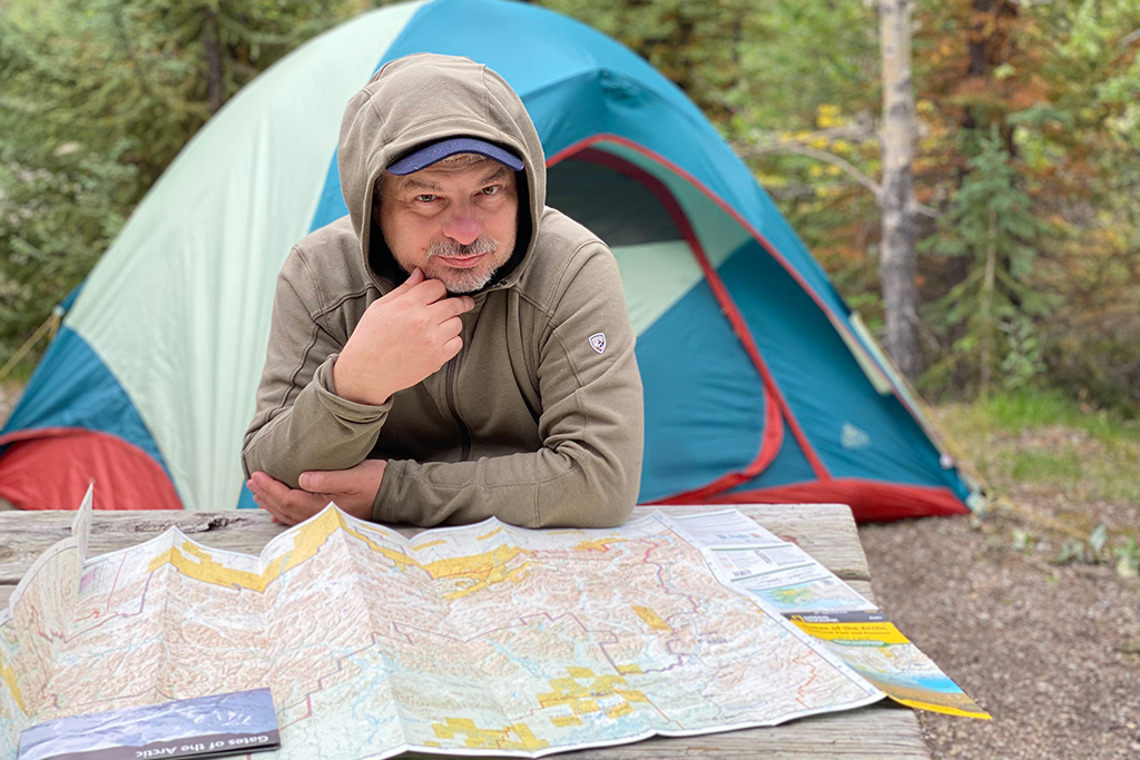 Chris at the campsite with a paper map which we always pack for a day hike.