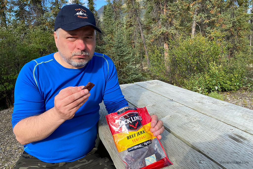 Chris eating beef jarky which ae always on our day hiking packing list.