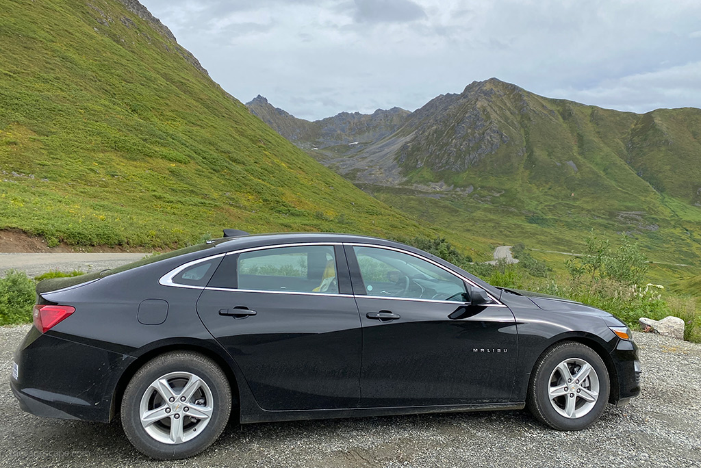 black malibu car with the mountain view during our Alaska road trip.