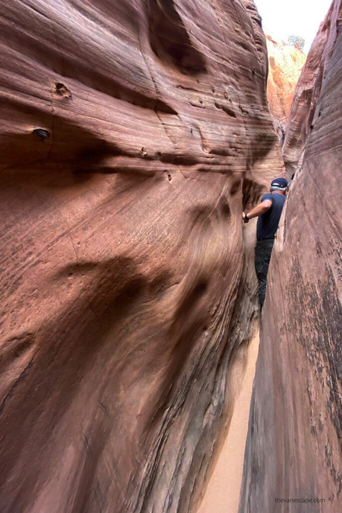 Chris squeezing Zebra Slot Canyon in Utah