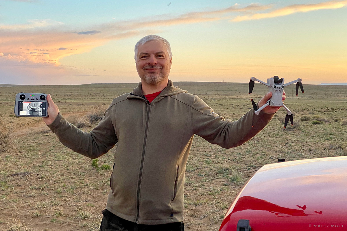 Chris Labanowski, co-owner of the Van Escape blog, with is DJI Mini 3 Pro Drone in his hands during stunning sunset.