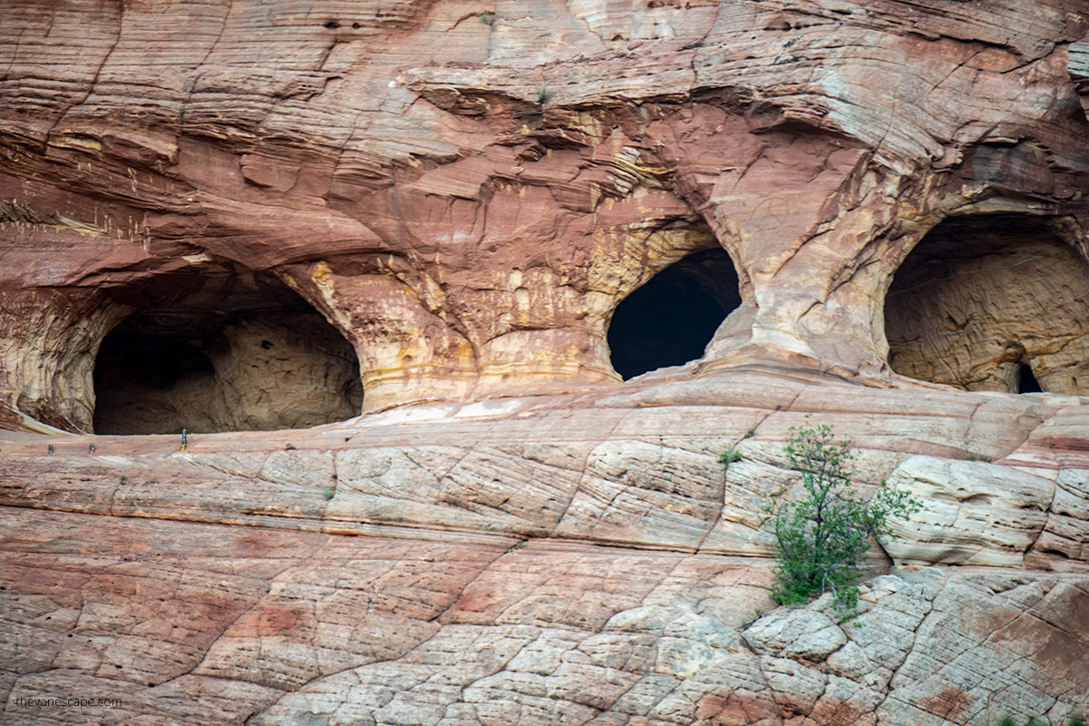 view of Moqui Caverns from the road: three big holes in the wall.