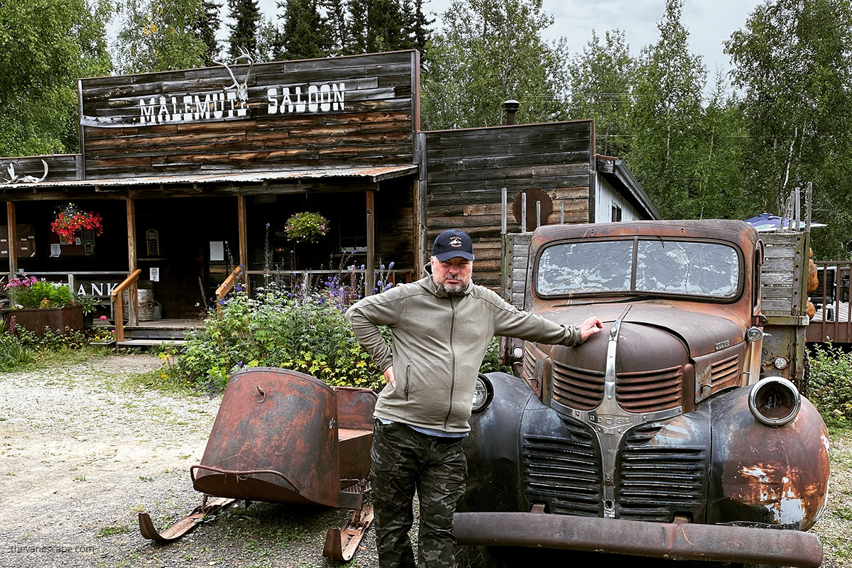 Chris with old car at the front of Malemute Saloon in Easter Gold Camp