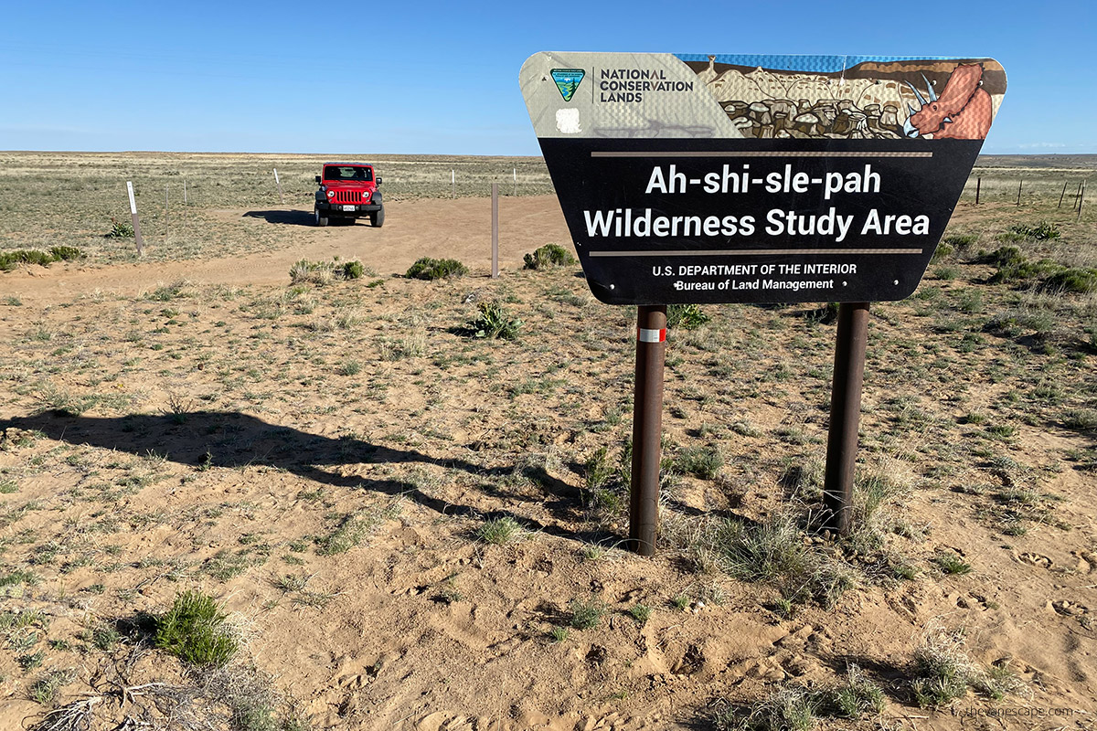 Ah-Shi-Sle-Pah Wilderness sign and parking lot with our rented red jeep wrangler