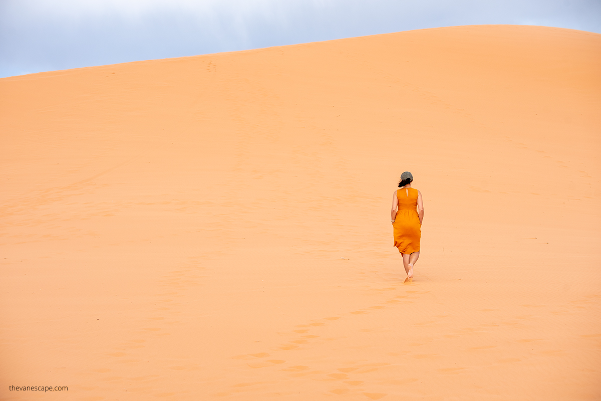 Agnes Stabinska, the author, is hiking on the deep sand in Coral Pink Sand Dunes State Park