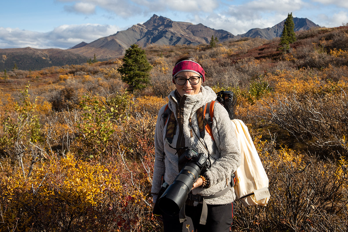 Agnes with her camera hiking in Denali wilderness in September