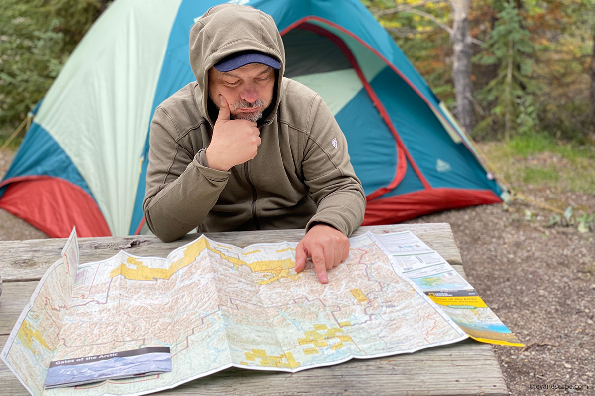 chris with the map on our campsite near coldfoot, planning how to visit gates of the arctic national park