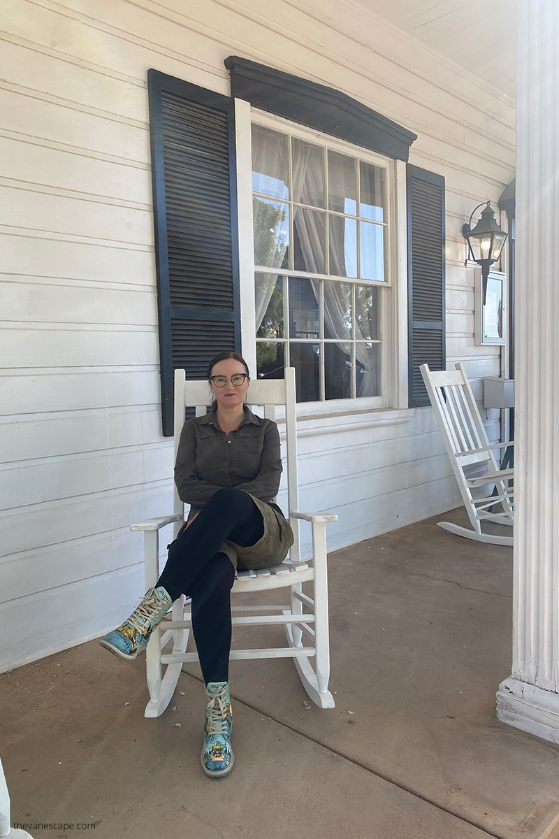 Agnes sitting on the white chair on the porch of Parry Lodge in Kanab