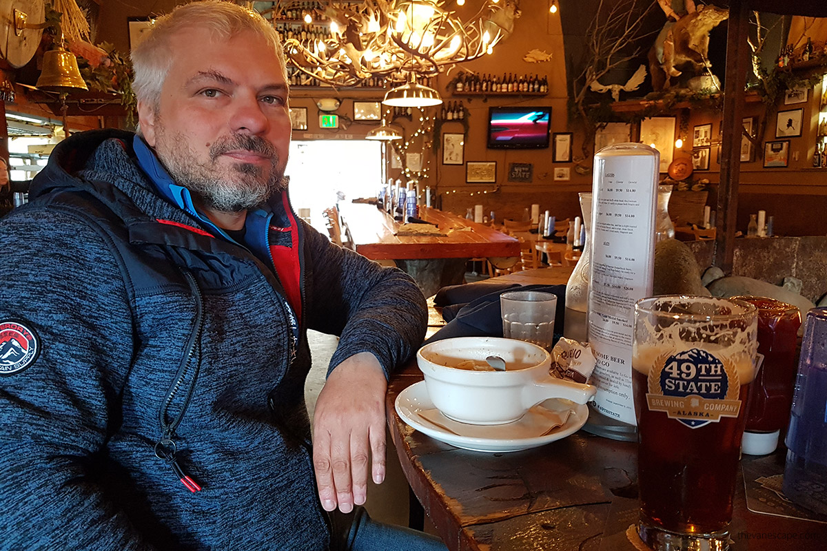 Chris eating and drinking Alaskan bear in Healy near Denali