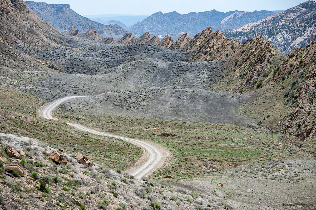 serpentine road with mountain backdrop