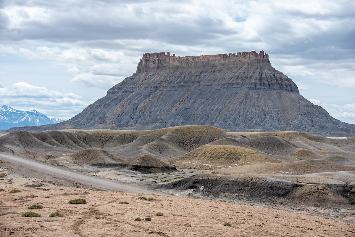 the huge Factory Butte shimmering with shades of gray and rust