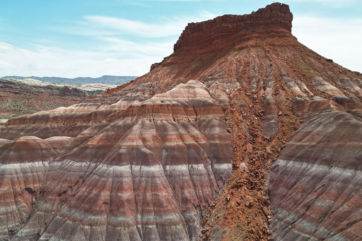 Famous rock in Paria Townsite in Utah was a movie set for many Western films. The rock has many colors, shades of rust, red, purple, purple, gray, and white.